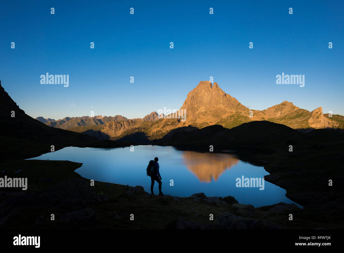 Taking in the view of Midi d'Ossau beyond Lac Gentau beside the GR10 trekking route in the French Pyrenees, Pyrenees Atlantiques, France, Europe Stock Photo