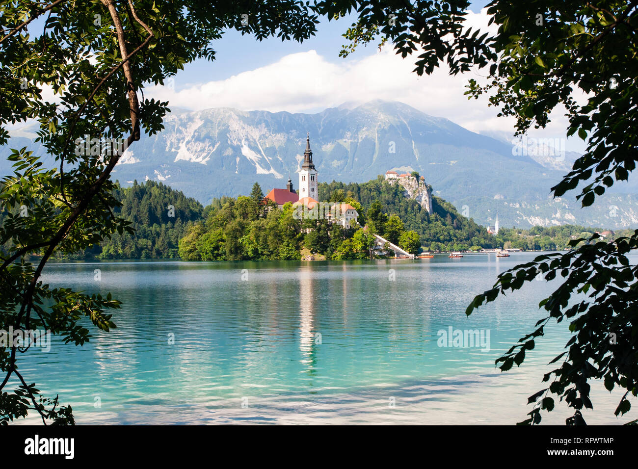 Tiny island with a church, a castle on a crag, and mountain views, Lake Bled, Slovenia, Europe Stock Photo