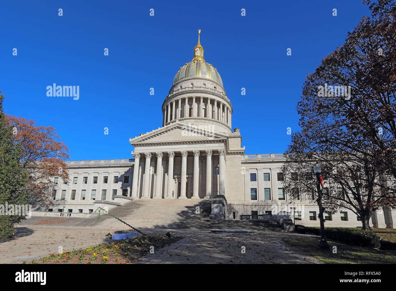 Front entrance and dome of the West Virginia capitol building along the Kanawha River in Charleston against a blight blue autumn sky Stock Photo