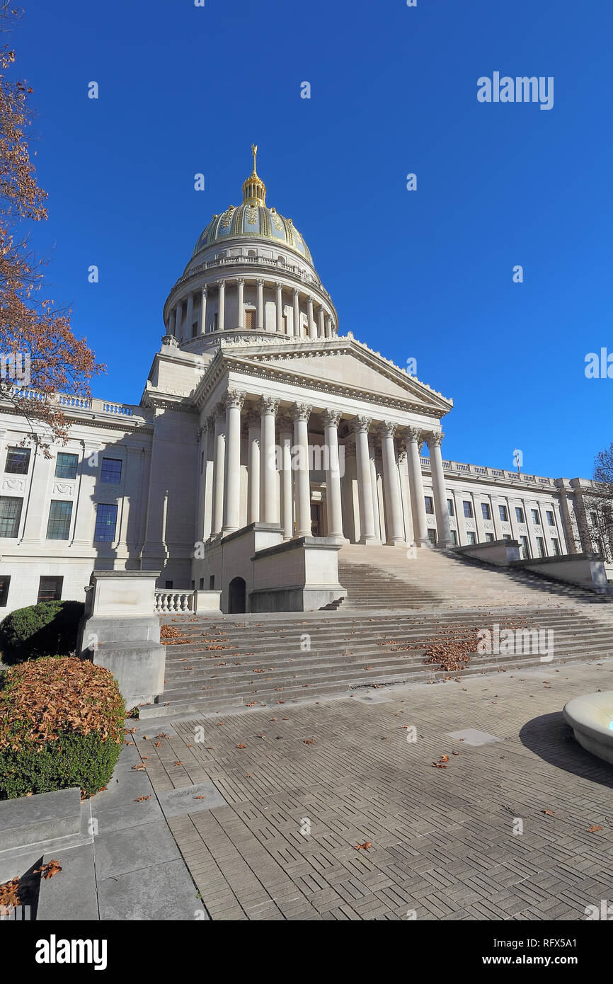 Front entrance and dome of the West Virginia capitol building along the Kanawha River in Charleston against a blight blue autumn sky vertical Stock Photo