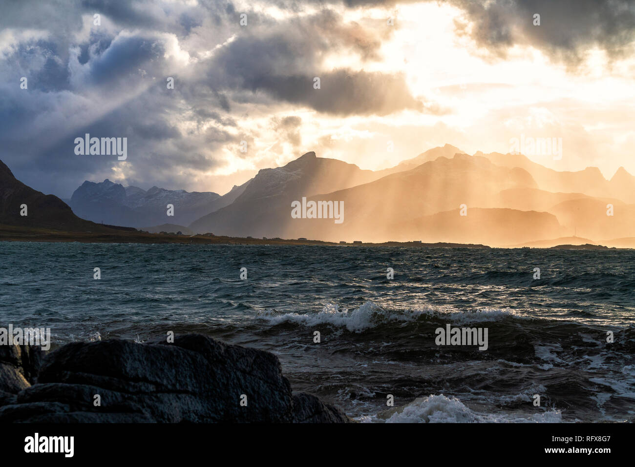 Sun rays above the rough sea of Flakstadoya seen from Vareid, Nordland, Lofoten Islands, Norway, Europe Stock Photo