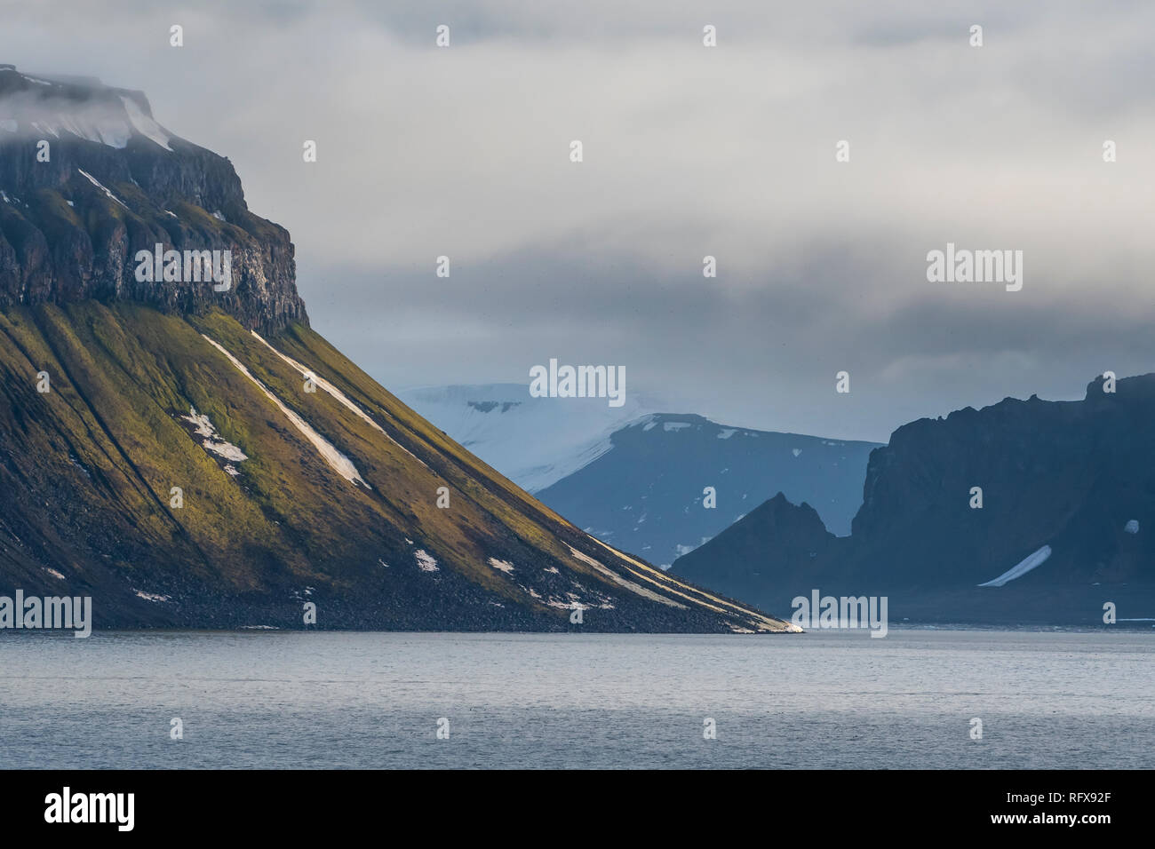 Green cliff in the glacier covered mountains of Franz Josef Land archipelago, Arkhangelsk Oblast