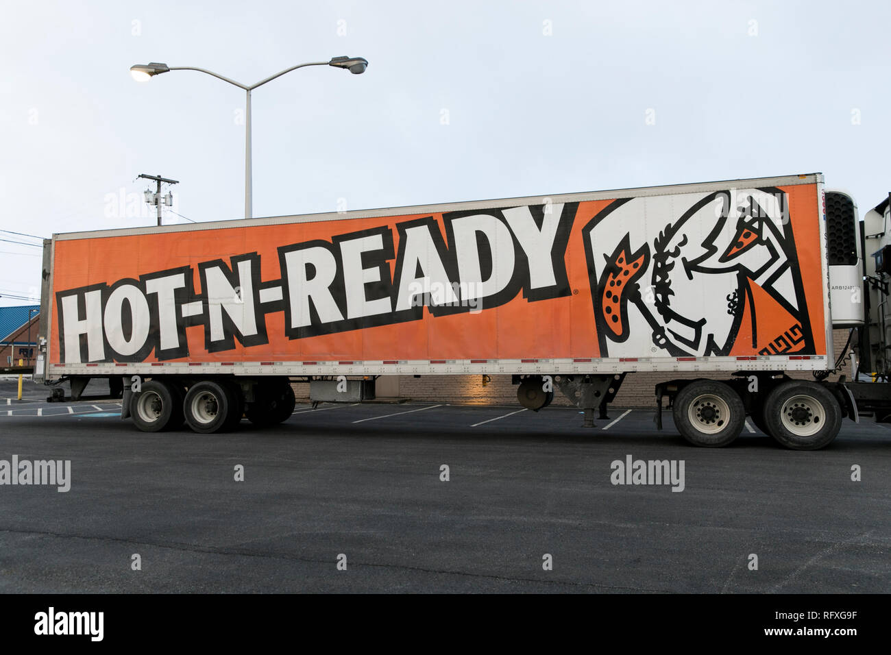 A logo sign outside of a Little Caesars restaurant location in