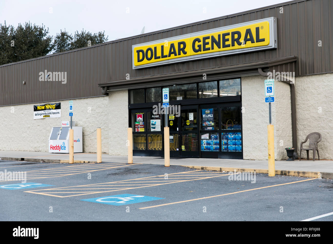 A logo sign outside of a Dollar General retail store location in