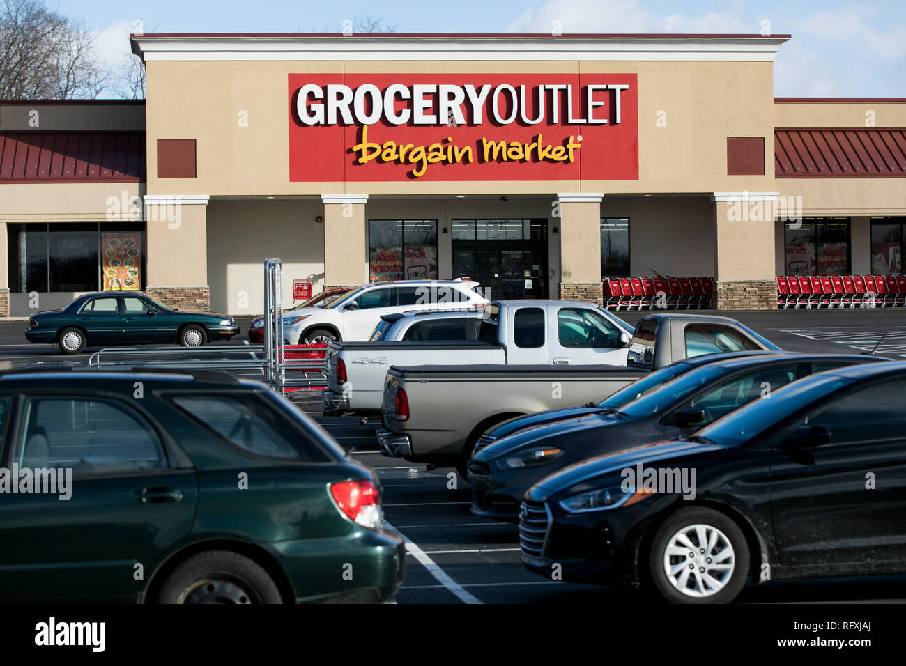 A logo sign outside of a Grocery Outlet retail grocery store location