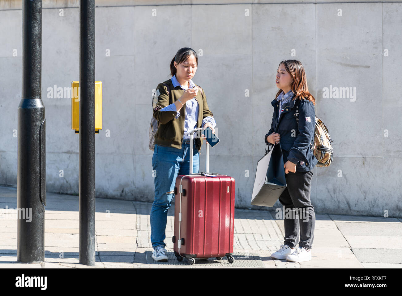 London, UK September 13, 2018 People standing outside with luggage