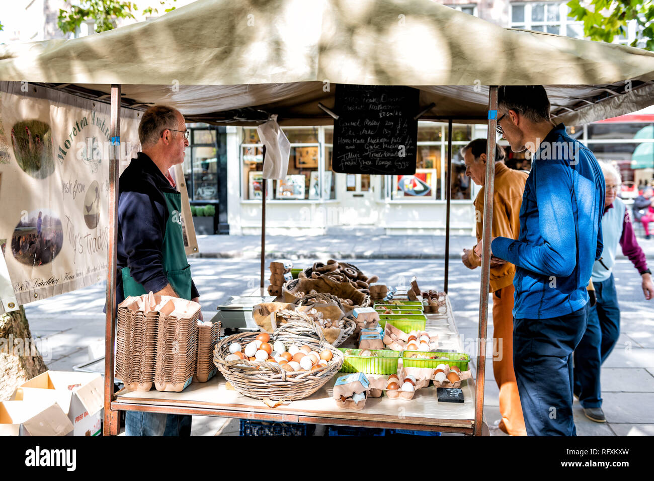 London, UK - September 15, 2018: Neighborhood market in Pimlico with standing on street road at fresh eggs vendor stand with customers Stock Photo