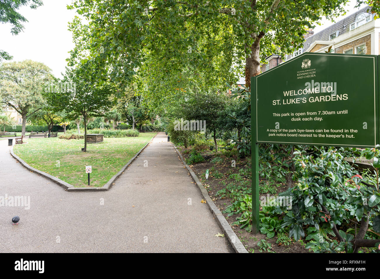 London, UK - September 16, 2018: Green St Luke's Gardens Park sign with nobody on path in Chelsea Kensington during autumn Stock Photo