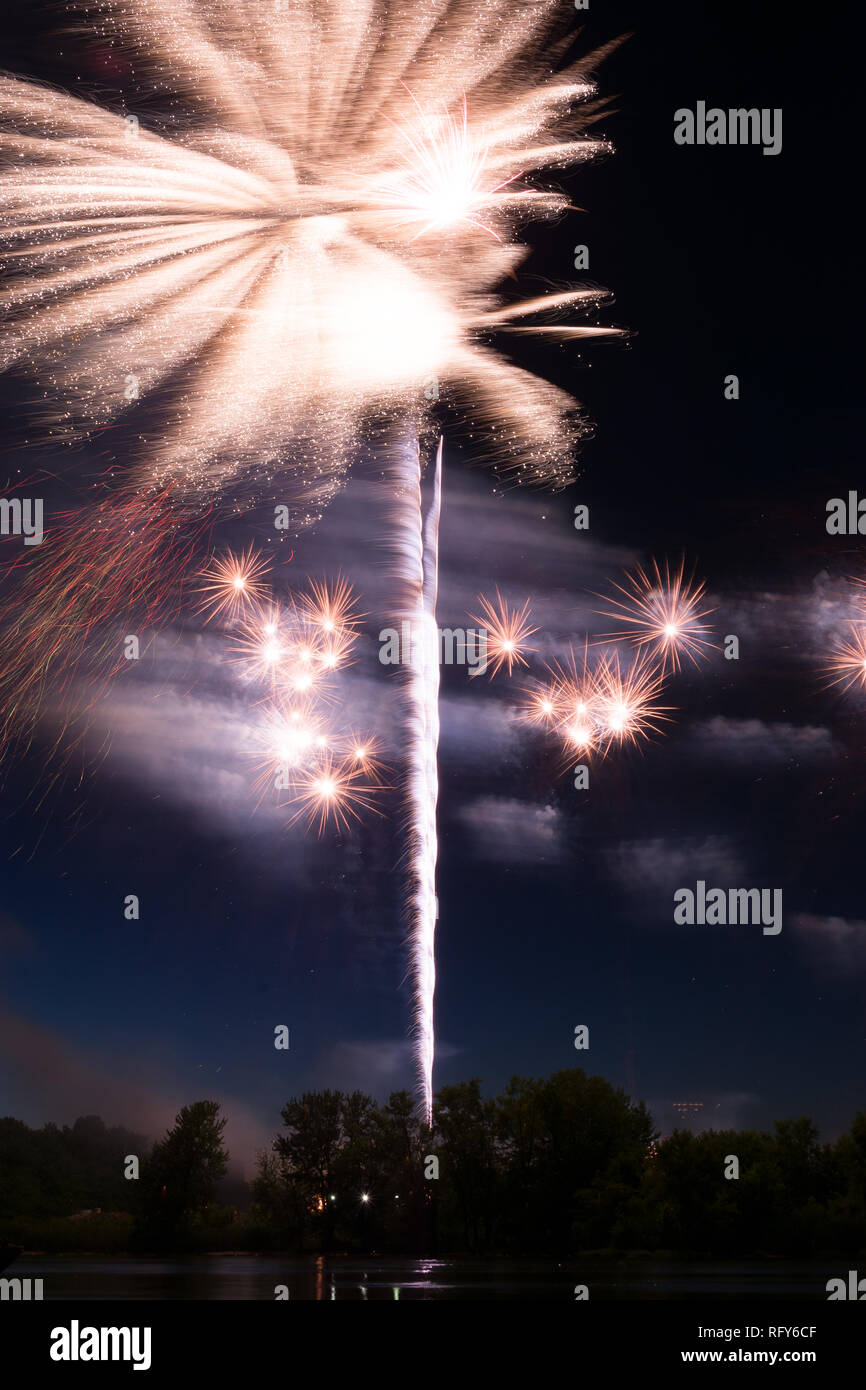 Assorted colored fireworks over the Illinois River on 4th of July