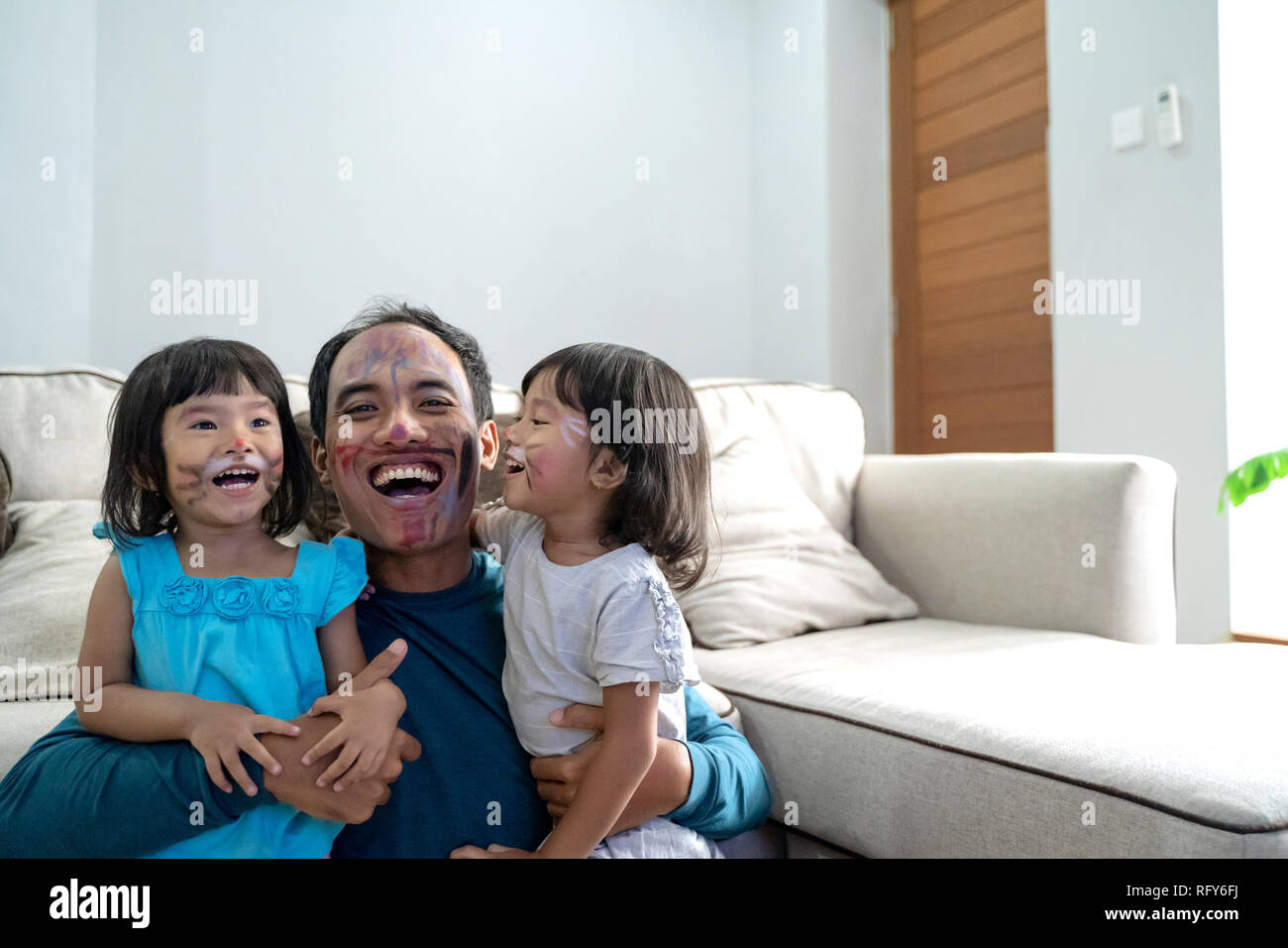 face painting with daddy at home Stock Photo Alamy