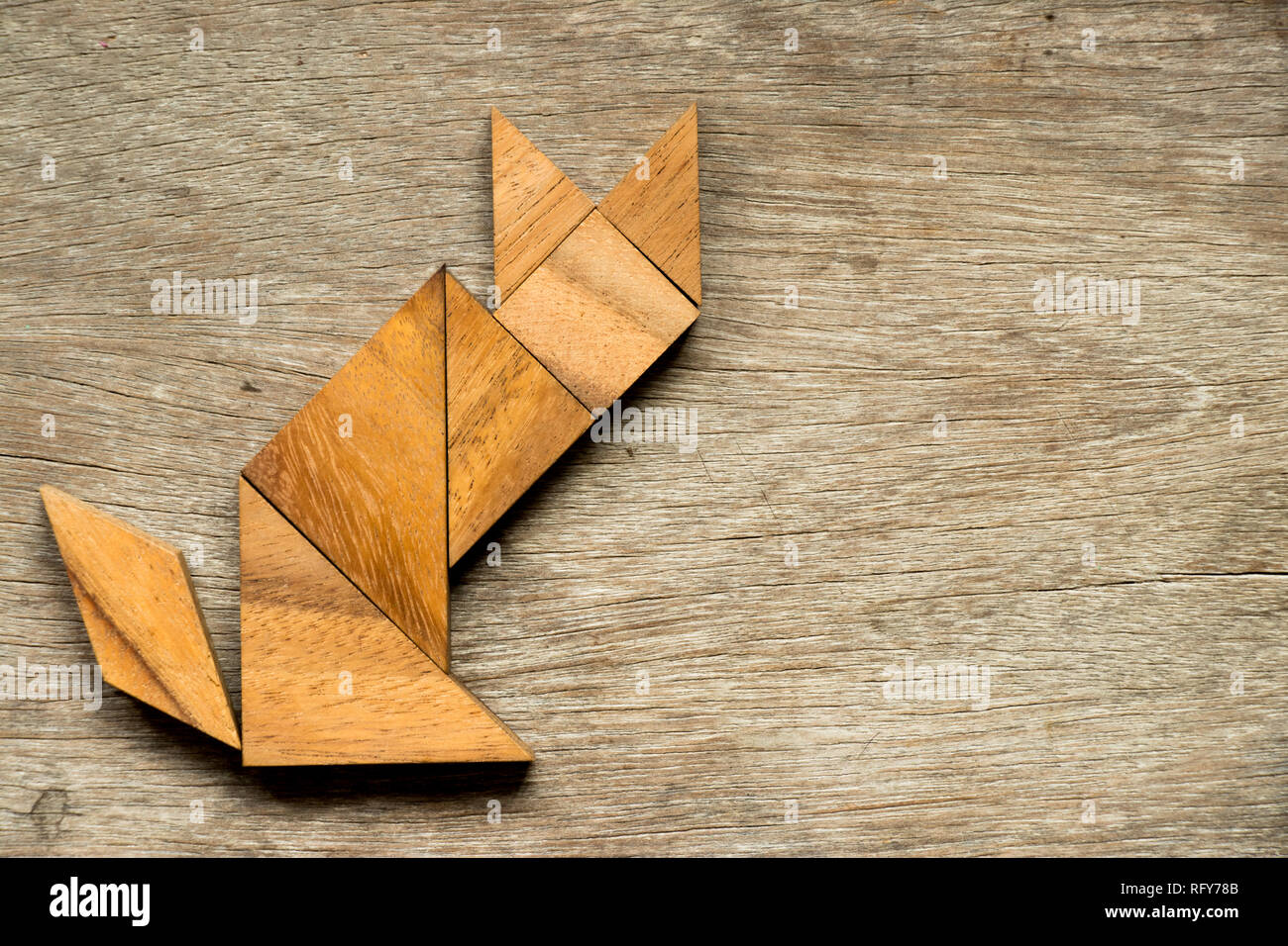 Tangram puzzle in cat sitting shape on wood background Stock Photo - Alamy