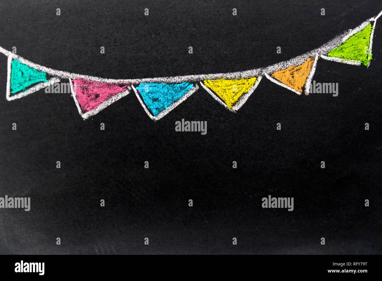 Chalk drawing as colorful party flag on black board background with