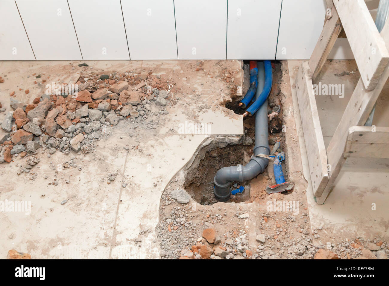 Repair plastic polypropylene gray sewer pipes in the hole in the brick