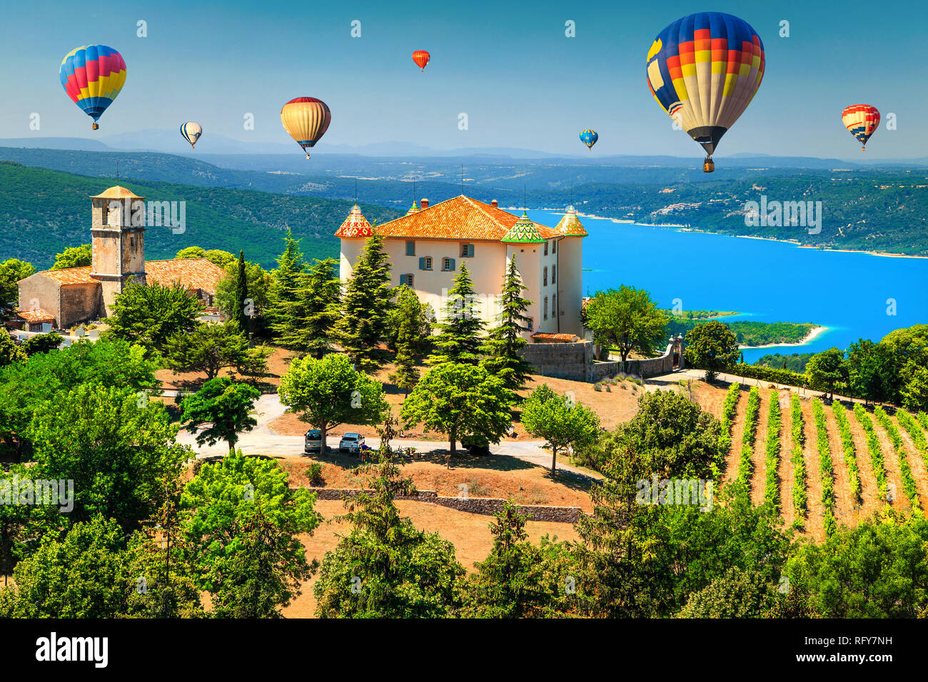 Fabulous Aiguines castle and spectacular vineyard. Amazing turquoise St Croix lake with colorful hot air balloons, near Verdon gorge, Provence, France Stock Photo