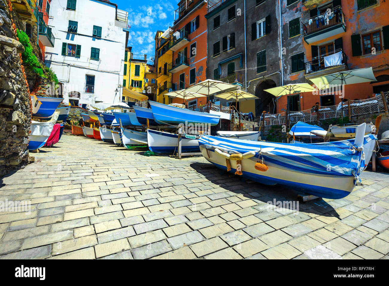 Breathtaking Riomaggiore touristic village and travel destinations. Admirable street view with wooden fishing boats and traditional colorful buildings Stock Photo