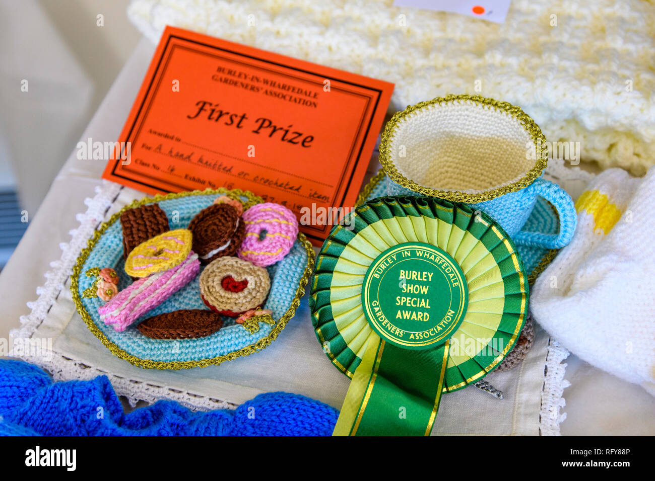 1st prize winning competition entry, certificate & rosette for knitted biscuits & cup handicraft - Gardeners' Show, Burley-in-Wharfedale, England, UK Stock Photo