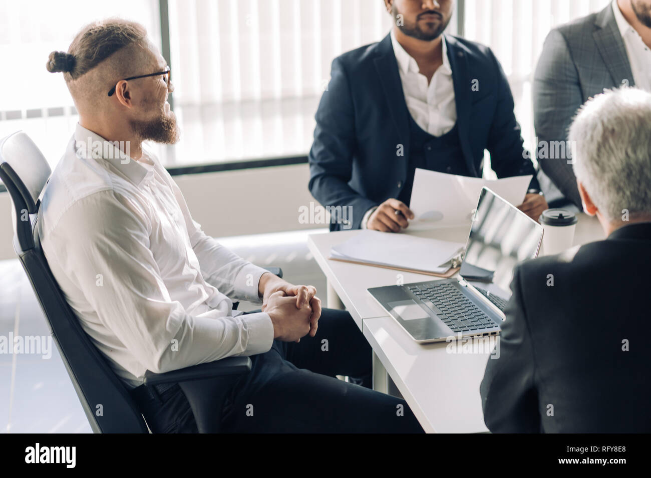 Corporate interracial business team with cheerful leader in a meeting, close up Stock Photo