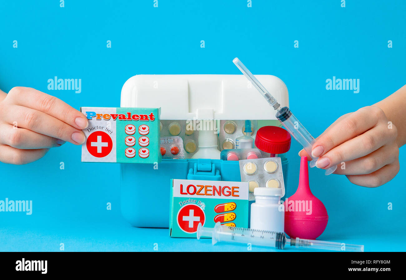 Flat lay composition with first aid kit on blue background. Stock Photo
