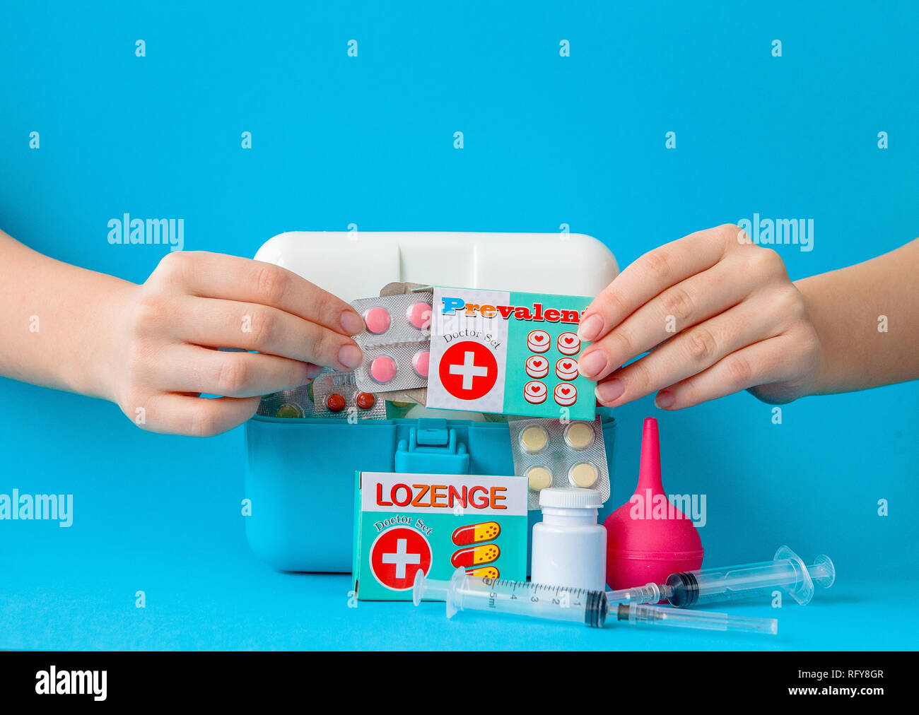 Flat lay composition with first aid kit on blue background. Stock Photo