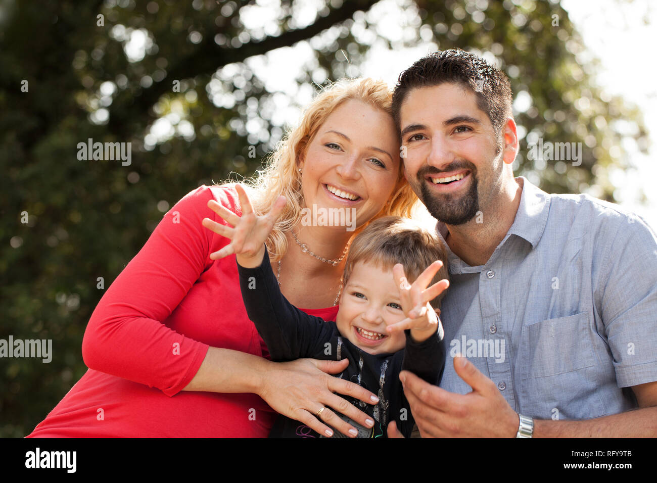 Young family in nature on sunny day Stock Photo