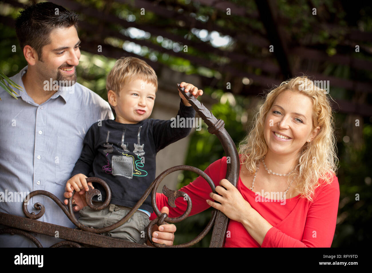 Young family in nature on sunny day Stock Photo