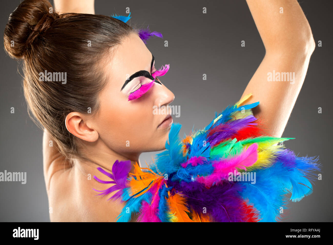 Beautiful young female model with bold make-up and feathers Stock Photo