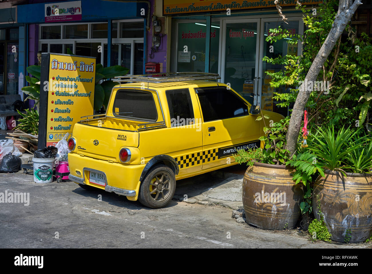 Daihatsu Mira 'mini' vehicle and it's off road parking ability. Thailand street, Southeast Asia Stock Photo