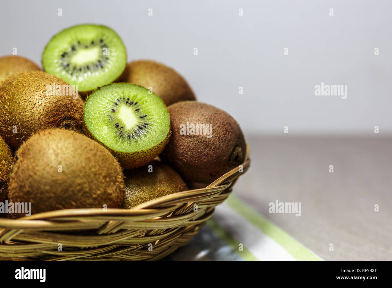 Ripe kiwi fruits in a basket. Healthy nutrition concept. Stock Photo