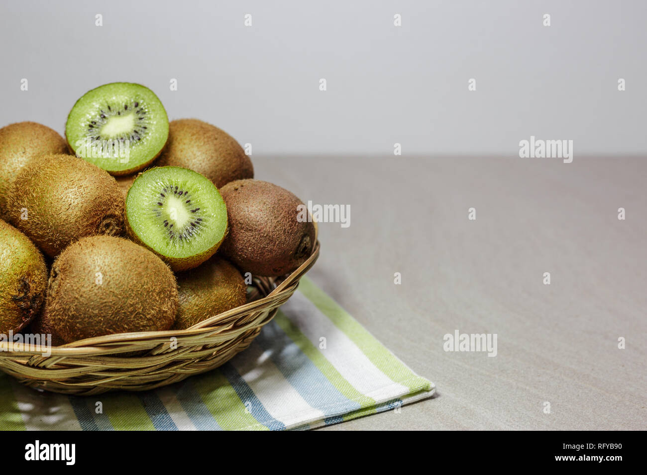 Ripe kiwi fruits in a basket. Healthy nutrition concept. Stock Photo