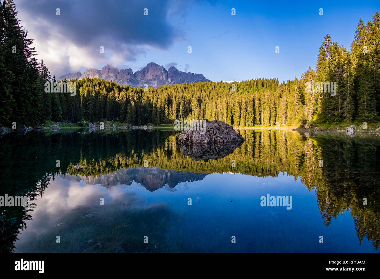 The mountains Rosengarten group, Catinaccio, mirroring in the lake Karersee, Lago di Carezza Stock Photo