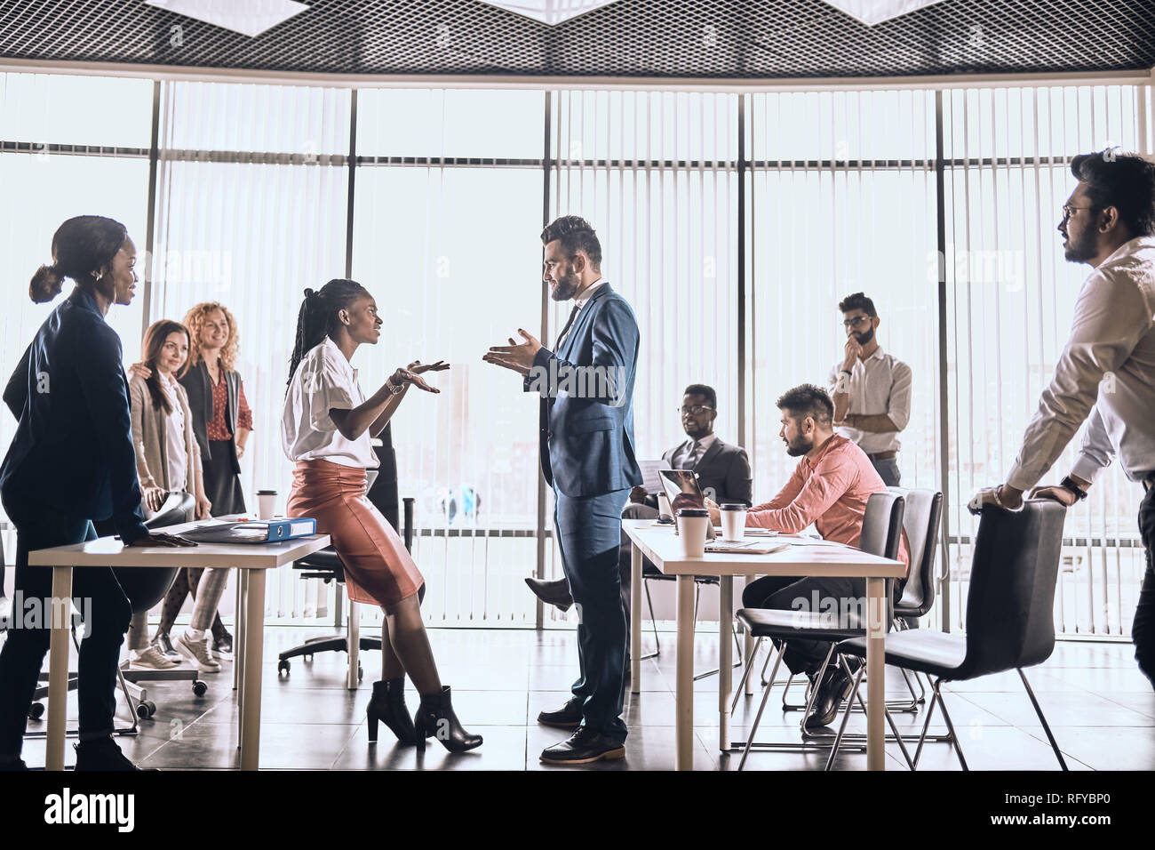 two employees are having a conflict . two views on the problem. Stock Photo