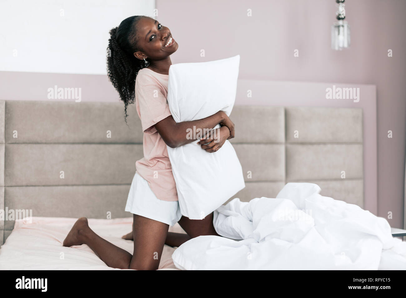 Woman hugging cheap pillow