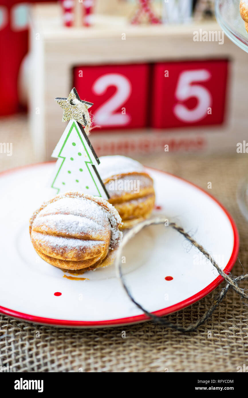 Christmas dessert concept with walnut shaped cookies stuffed with caramel cream Stock Photo
