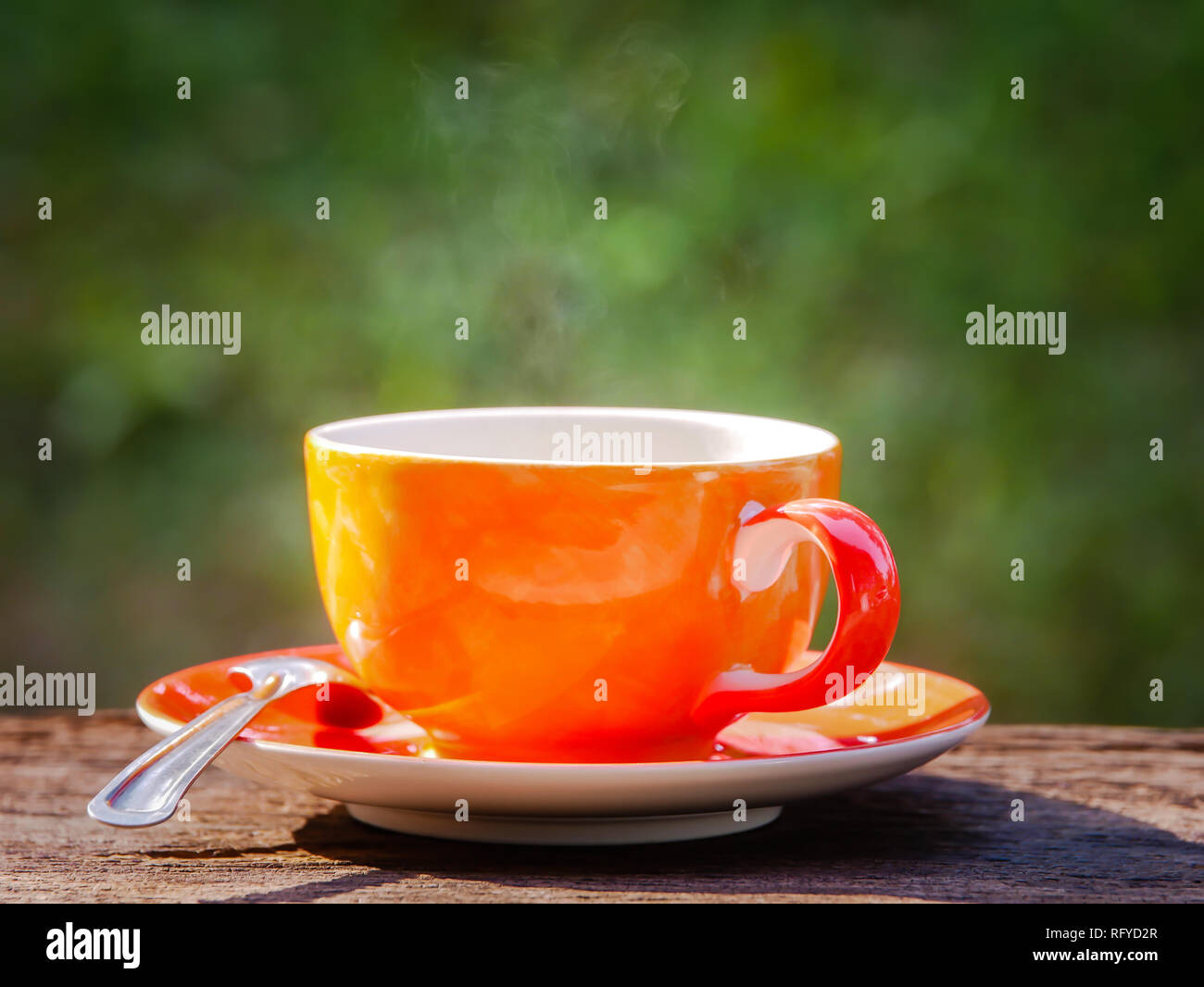 hot coffee cup on natural green background at morning time Stock Photo