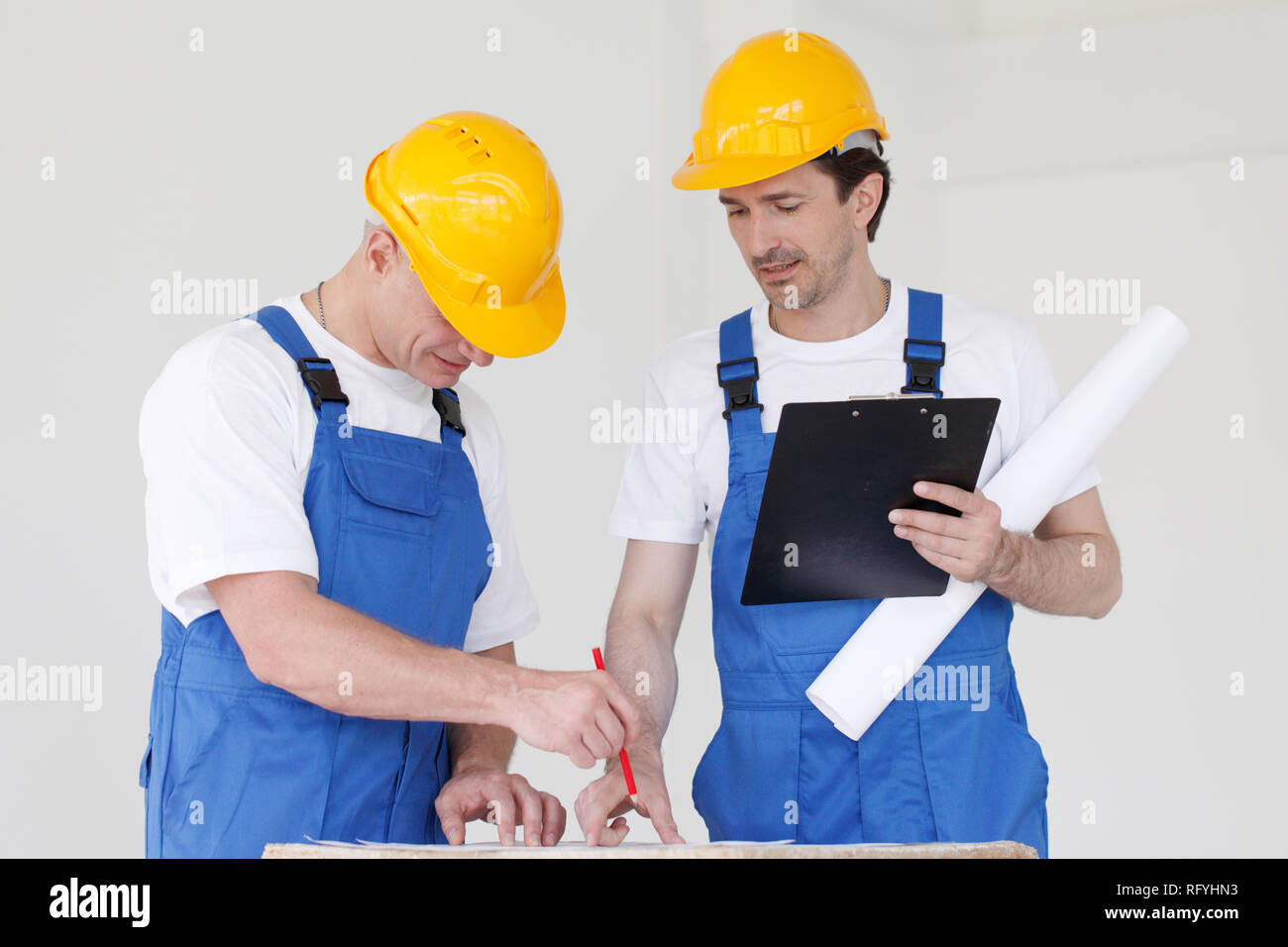 Workers discuss renovation project using digital tablet Stock Photo