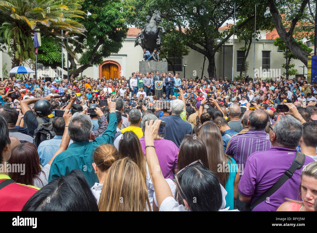 Group of citizens in the press conference of the interim President of Venezuela, Juan Guaidó, held in the Plaza Bolívar de Chacao Stock Photo