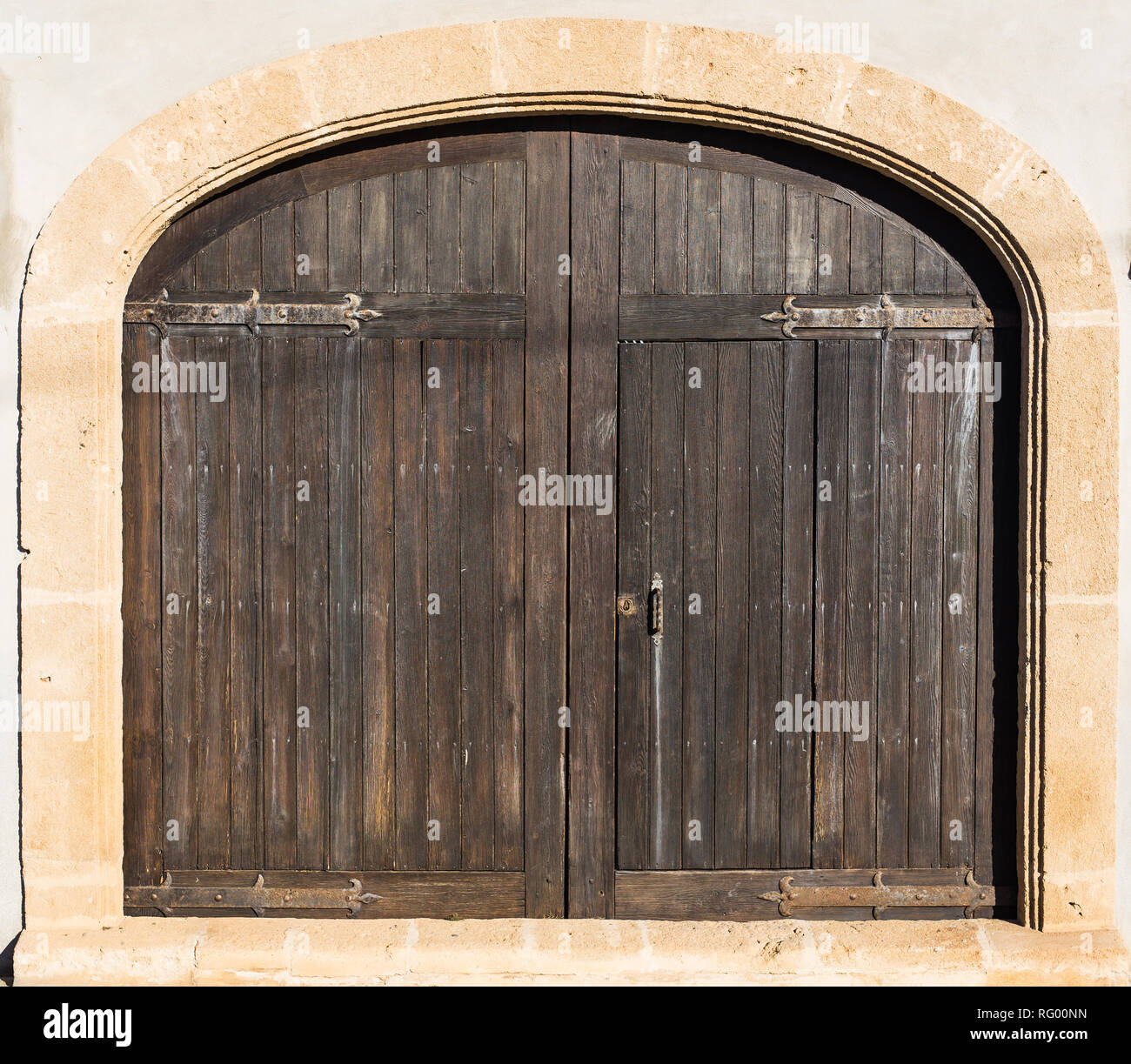 Medieval Brown Wooden Door in Stone Wall Stock Photo - Alamy