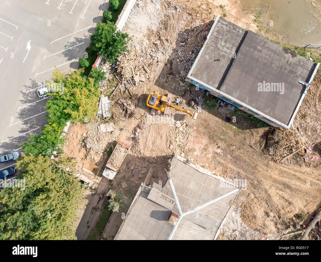 aerial view of heavy construction machinery. excavator and dump truck working at demolition site Stock Photo