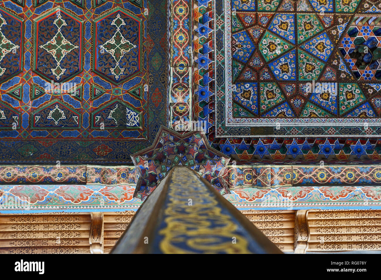 historic wooden column with ornate oriental carvings painted colorful, Tashkent, Uzbekistan Stock Photo