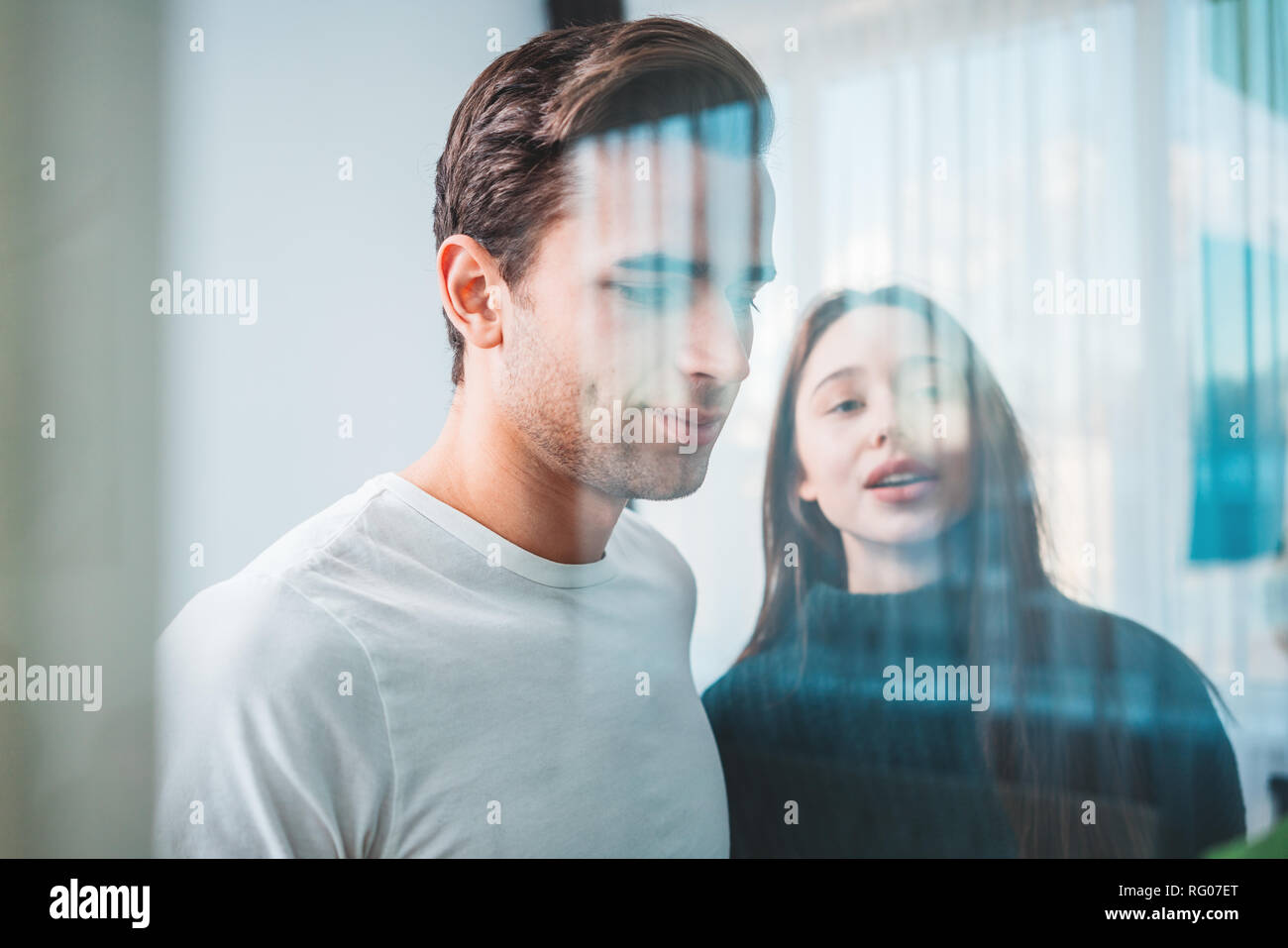 Portrait of coworker people standing at office space behind glass wall with sticky notes. Team of manager disscusing and brainstorming new sturtup ide Stock Photo