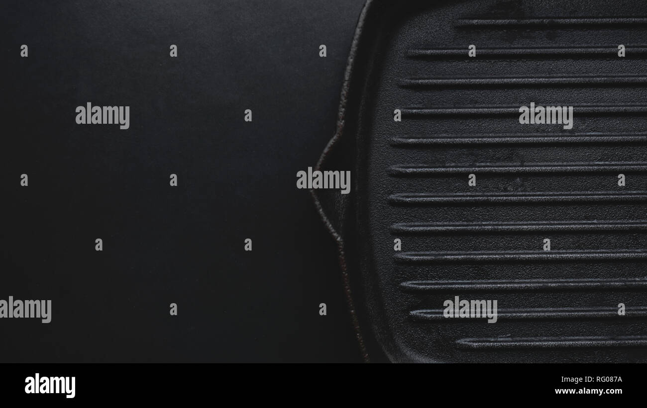 Cast iron griddle pan on black background Stock Photo - Alamy