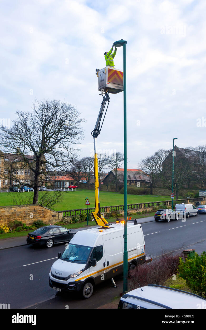 Man on an Hydraulic Hoist carrying out a repair on a street lamp post