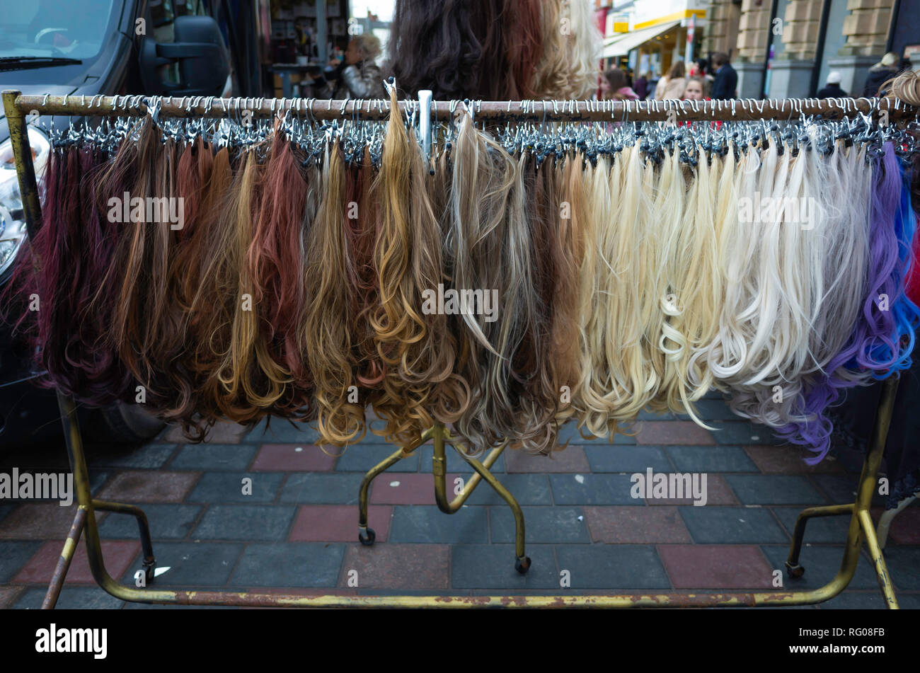 Display of artificial hair for women on sale at the weekly market in Darlington County Durham UK Stock Photo