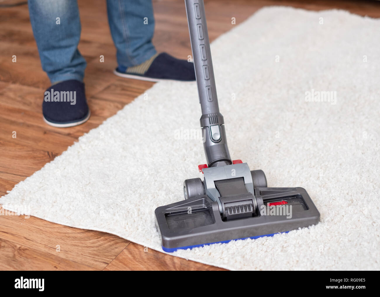 Close up of vacuum cleaner cleaning dirty carpet Stock Photo - Alamy