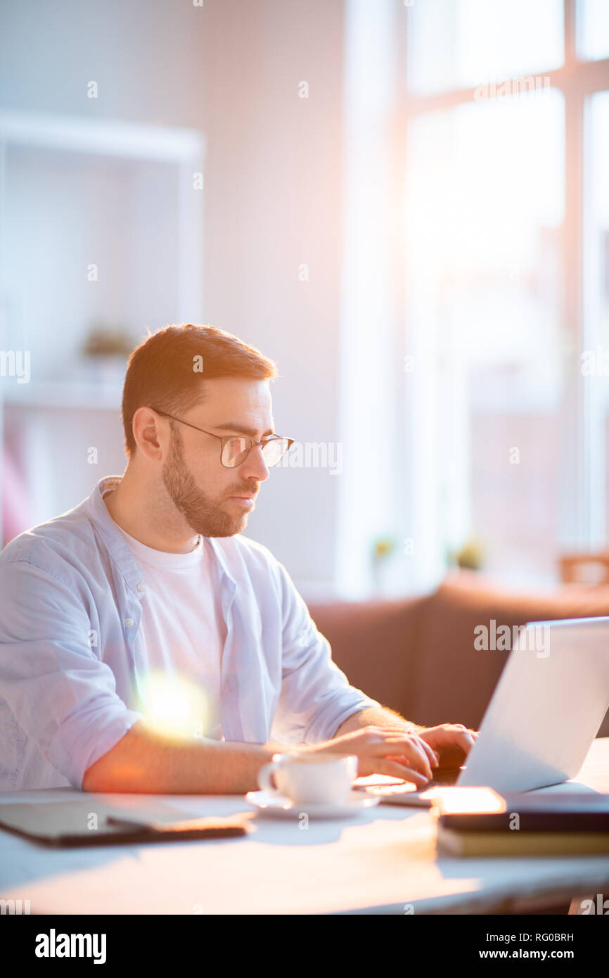 Man in front of laptop Stock Photo - Alamy