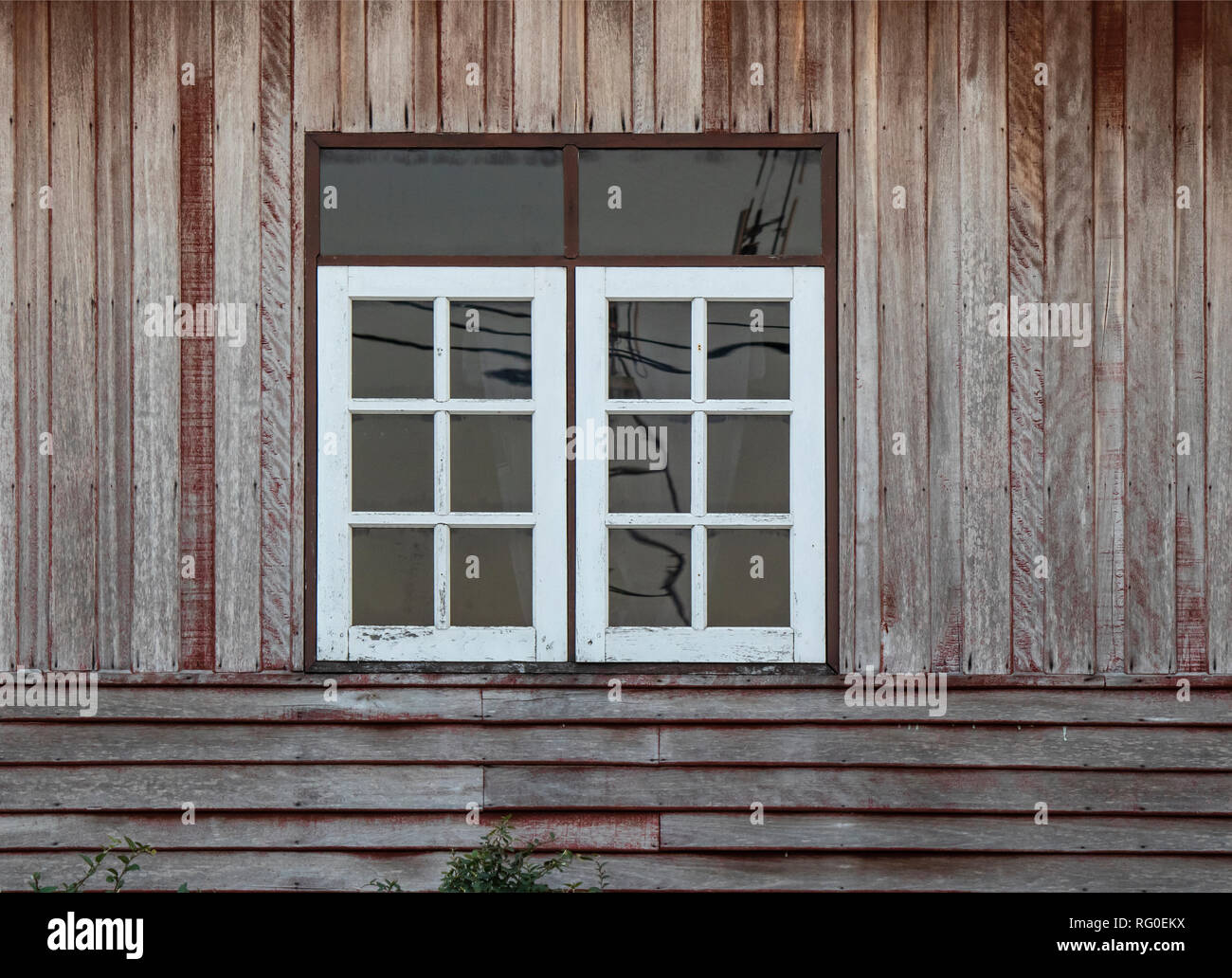White color windows and old brown color wooden wall. Stock Photo