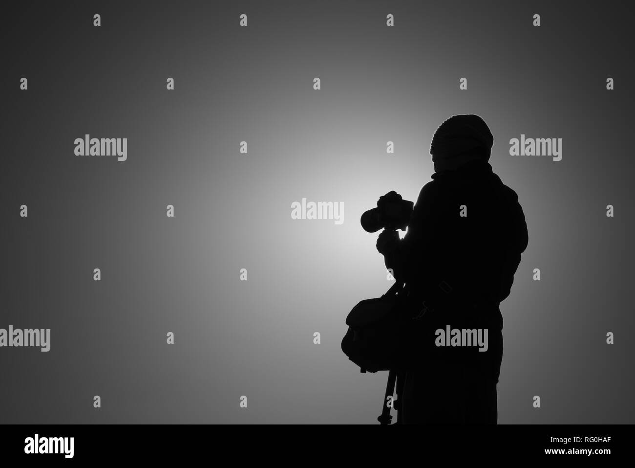 Silhouette of photographer taking photos. Filter effect style Stock Photo