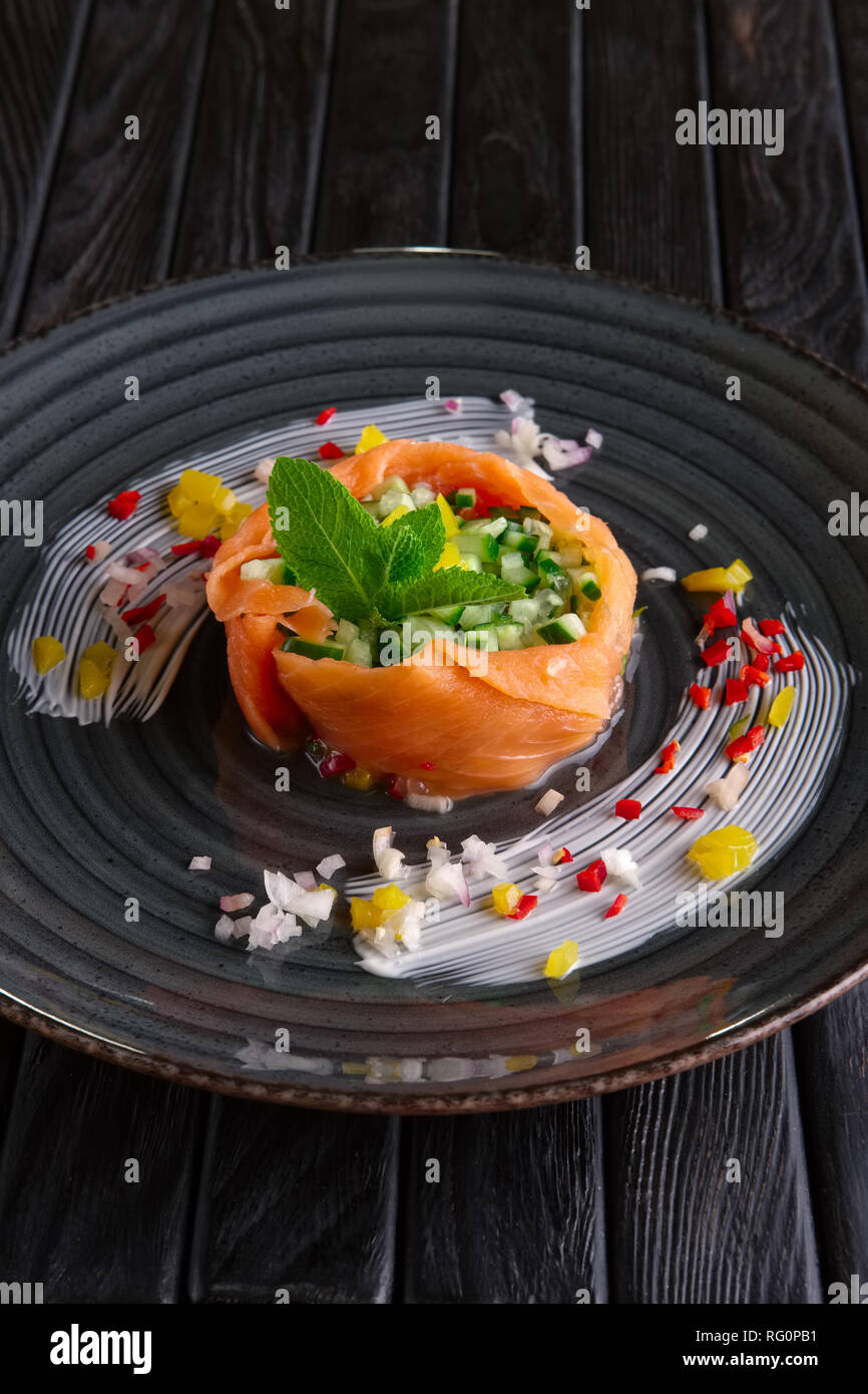 Smoked salmon stripes with cucumber, bell and chili pepper and onion Stock Photo