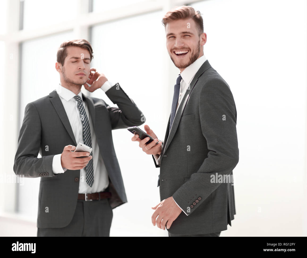 employees standing in the office hallway Stock Photo - Alamy