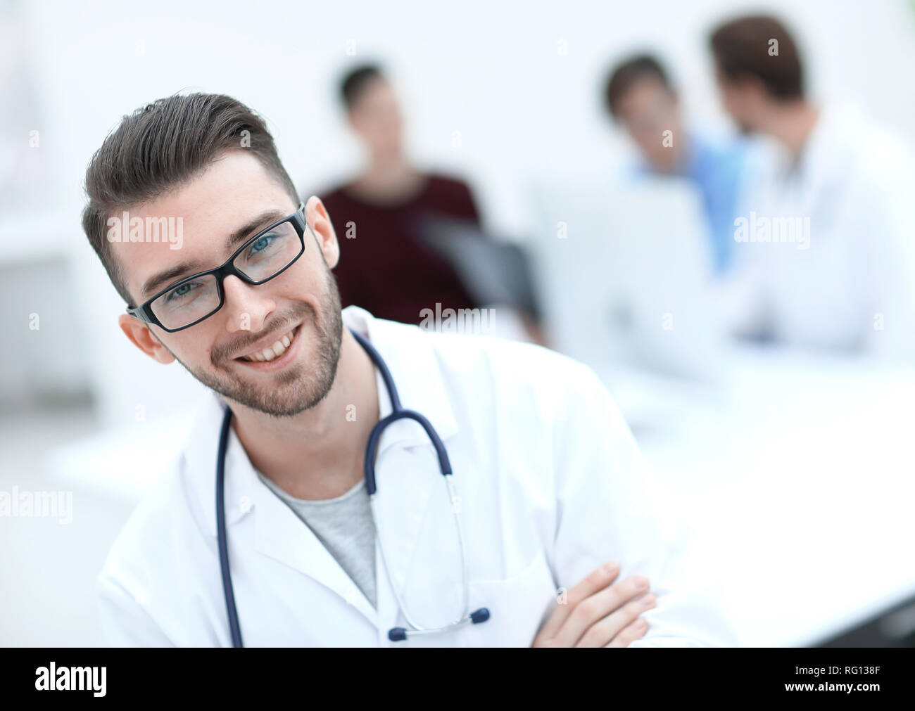 handsome doctor on blurred background Stock Photo - Alamy